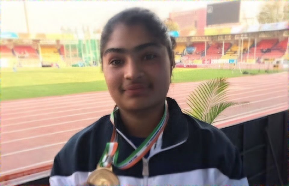 Jasmine Kaur holds a medal during a track and field event, before her suspension for doping.