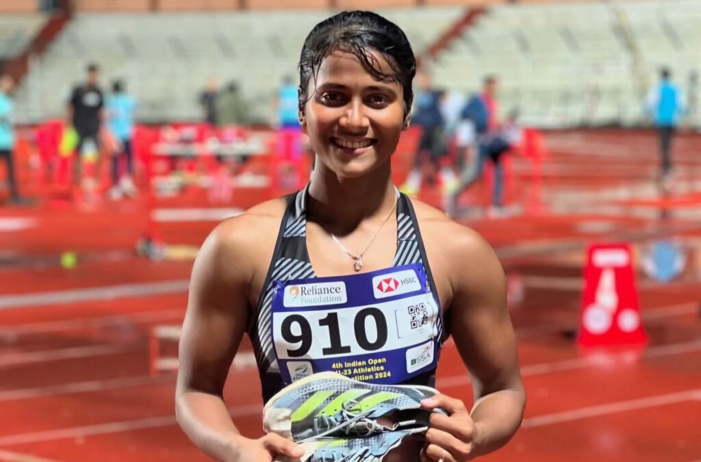 Moumita Mondal smiling after a hurdles race, captured in an competition.