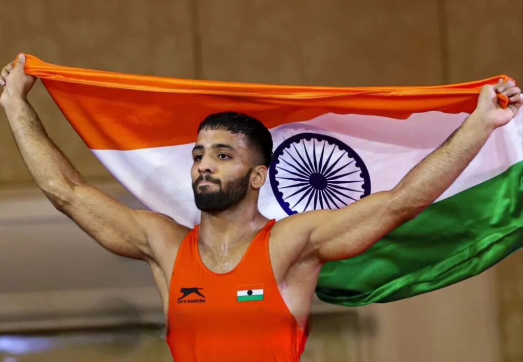 Sujeet Kalkal holding the Indian national flag after winning gold.